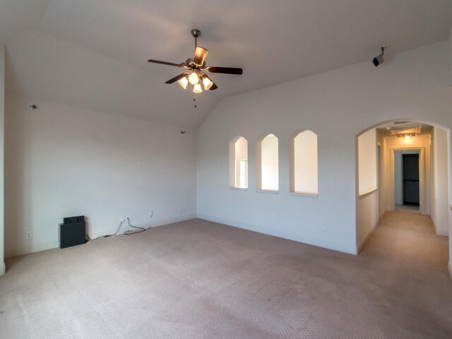 928 Freesia Dr, Little Elm, TX 75068 - empty room featuring vaulted ceiling, light carpet, ceiling fan, and arched walkways