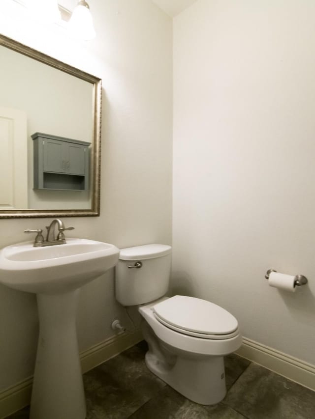 928 Freesia Dr, Little Elm, TX 75068 - bathroom featuring toilet, baseboards, and a sink