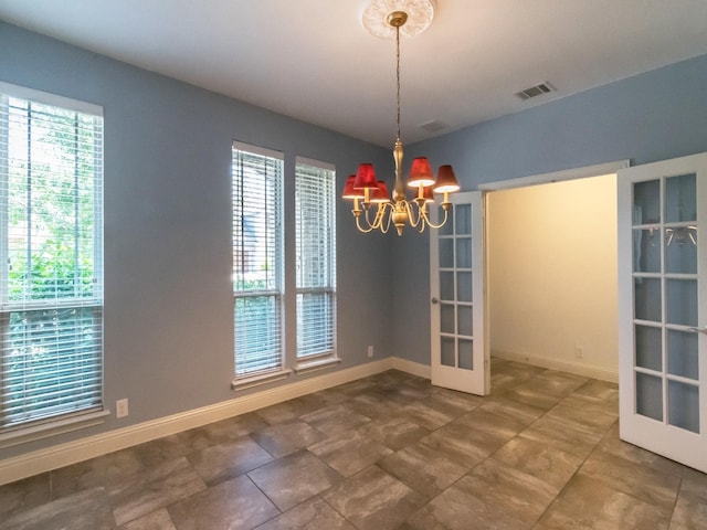 928 Freesia Dr, Little Elm, TX 75068 - spare room featuring a chandelier, french doors, and baseboards