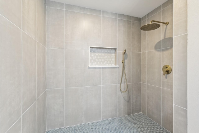 full bath with a tile shower