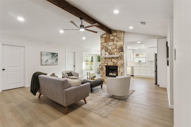 living room with a ceiling fan, light wood finished floors, a fireplace, and recessed lighting