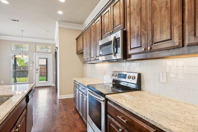 kitchen featuring stainless steel appliances, ornamental molding, light stone counters, dark wood-type flooring, and decorative backsplash