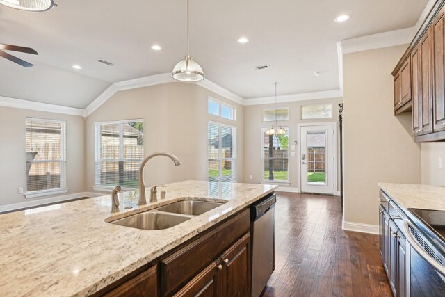 kitchen with a sink, appliances with stainless steel finishes, healthy amount of natural light, dark wood-style flooring, and recessed lighting