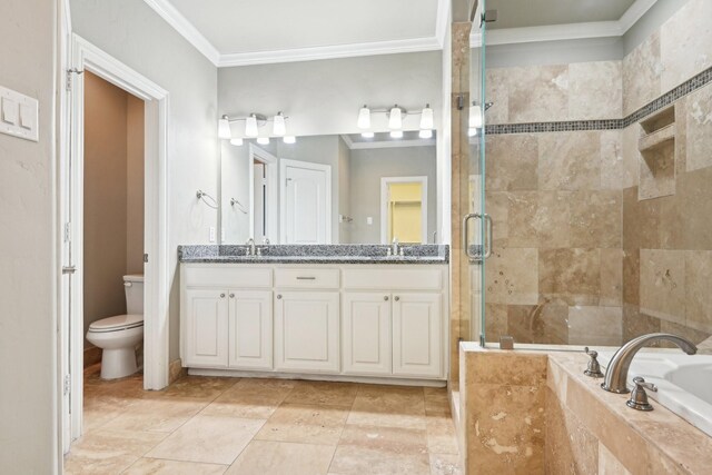 bathroom with crown molding, a shower stall, toilet, a garden tub, and double vanity
