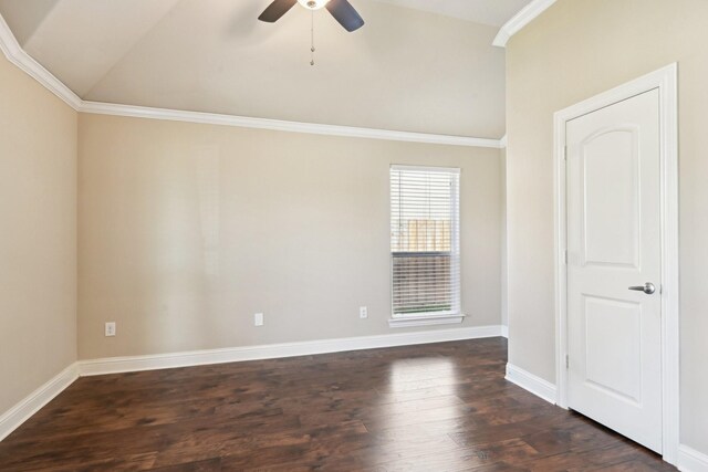 empty room featuring vaulted ceiling, a ceiling fan, dark wood-style floors, baseboards, and crown molding