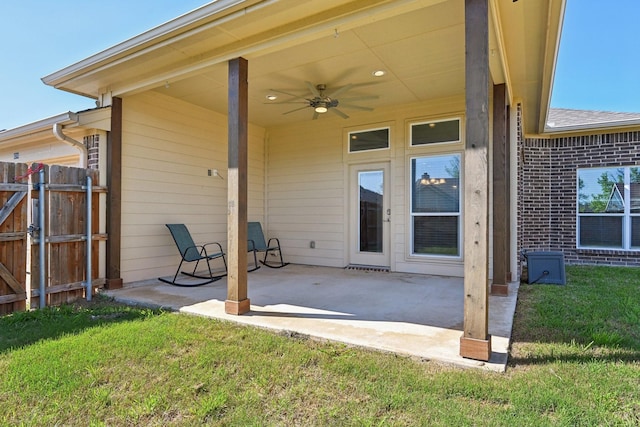 rear view of property featuring ceiling fan, a patio area, and brick siding