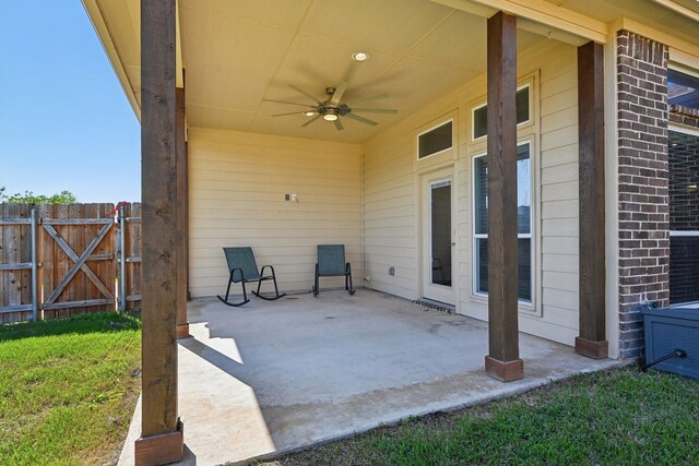 view of patio featuring ceiling fan and fence