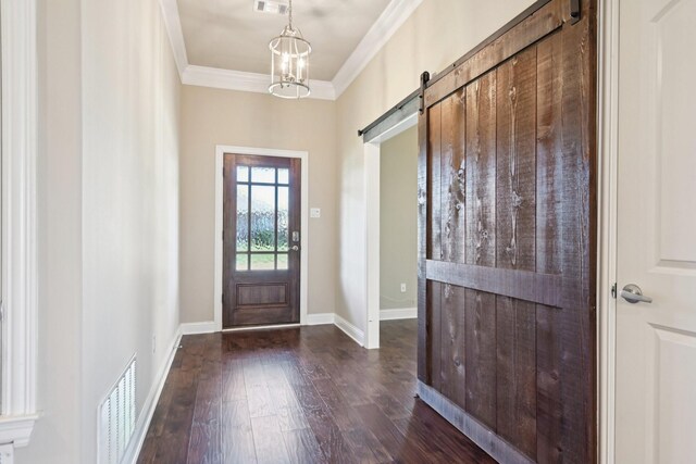 doorway to outside with crown molding, dark wood-type flooring, a barn door, and baseboards