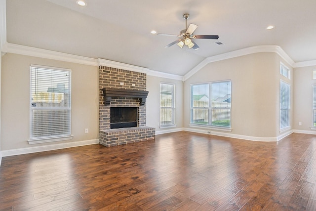 unfurnished living room with ceiling fan, lofted ceiling, ornamental molding, wood finished floors, and a fireplace