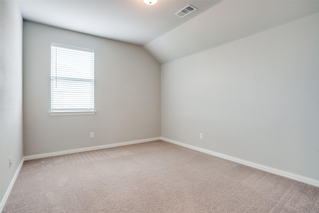 3001 Renmuir Dr, Prosper, TX 75078 - empty room featuring carpet flooring, vaulted ceiling, and baseboards