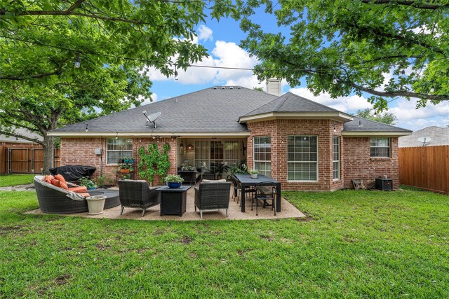 rear view of property with an outdoor hangout area, brick siding, a patio, and a chimney