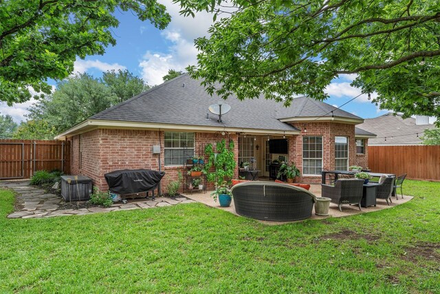 back of property featuring brick siding, a shingled roof, and a patio area