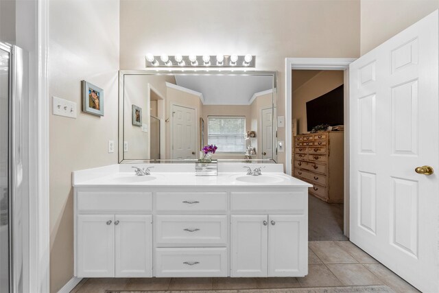 bathroom featuring double vanity, tile patterned floors, and ornamental molding