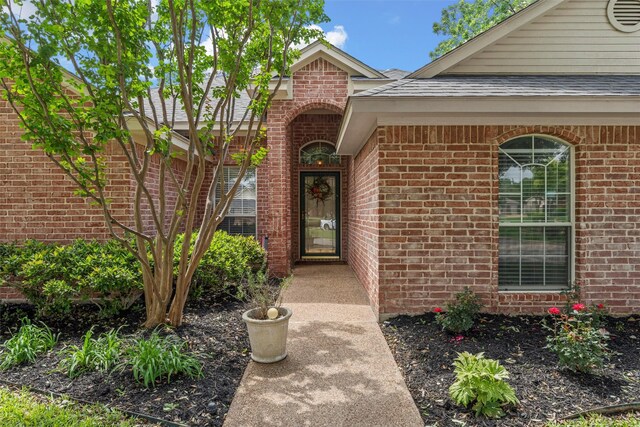 property entrance featuring brick siding