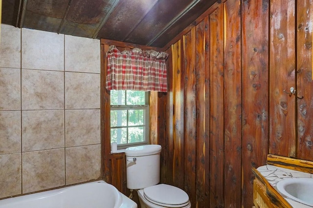 bathroom with toilet, a bath, and wooden walls