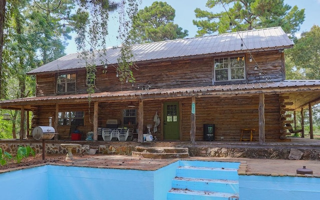 rear view of house with metal roof
