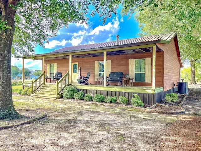 6861 County Road 4710, Larue, TX 75770 - view of front facade featuring a porch, metal roof, and central air condition unit