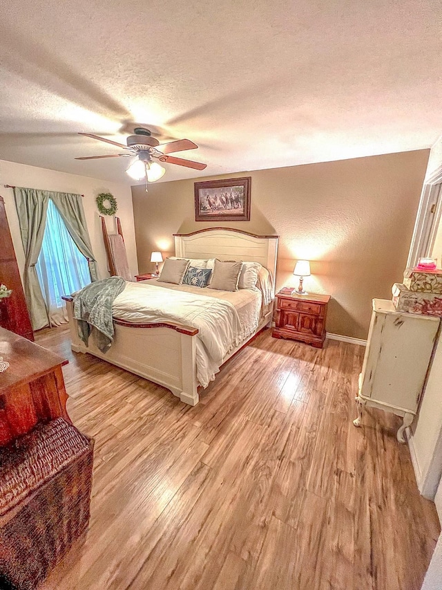 6861 County Road 4710, Larue, TX 75770 - bedroom with a textured ceiling, light wood finished floors, baseboards, and ceiling fan