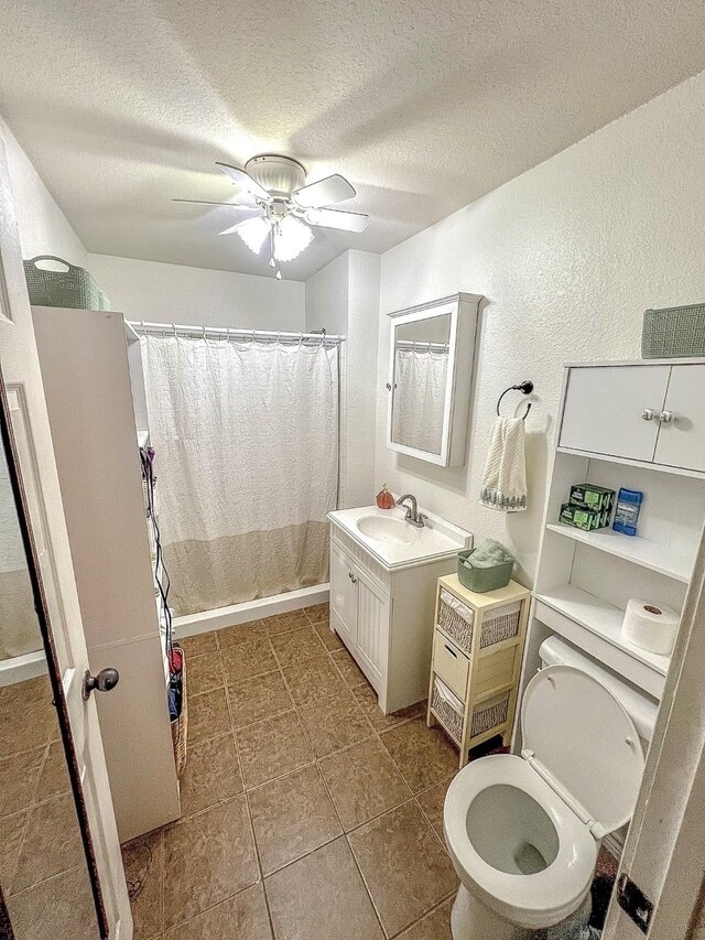 6861 County Road 4710, Larue, TX 75770 - full bath featuring toilet, a textured ceiling, vanity, tile patterned floors, and ceiling fan