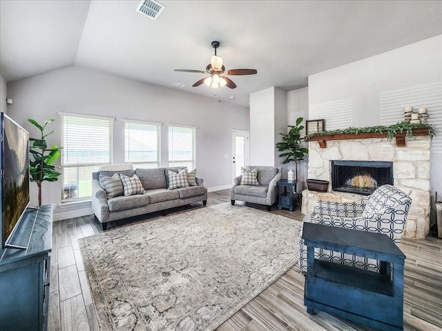 1152 Snowy Owl Dr, Alvarado, TX 76009 - living area featuring a stone fireplace, ceiling fan, wood finished floors, baseboards, and vaulted ceiling
