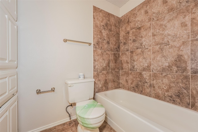 bathroom featuring toilet, baseboards, and tile patterned floors