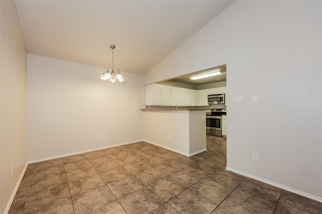 spare room featuring a chandelier, baseboards, and high vaulted ceiling