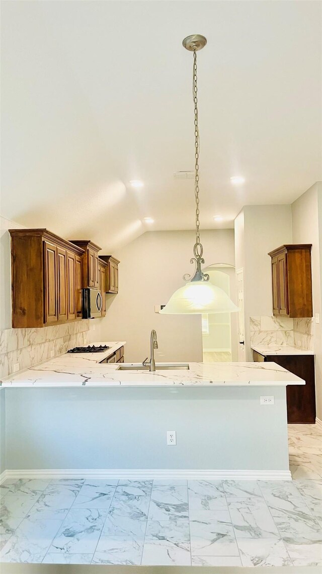 2632 Lake Ridge Dr, Little Elm, TX 75068 - kitchen featuring light marble finish flooring, hanging light fixtures, tasteful backsplash, and vaulted ceiling