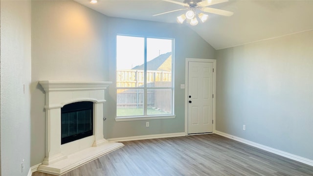 2632 Lake Ridge Dr, Little Elm, TX 75068 - unfurnished living room featuring wood finished floors, ceiling fan, a fireplace, vaulted ceiling, and baseboards
