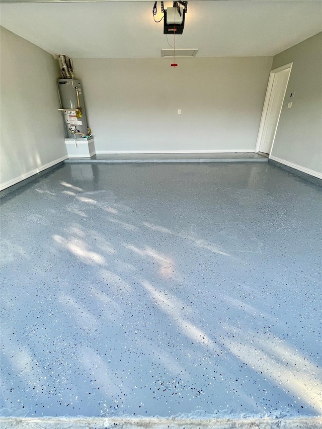 2632 Lake Ridge Dr, Little Elm, TX 75068 - garage with gas water heater, a garage door opener, and baseboards