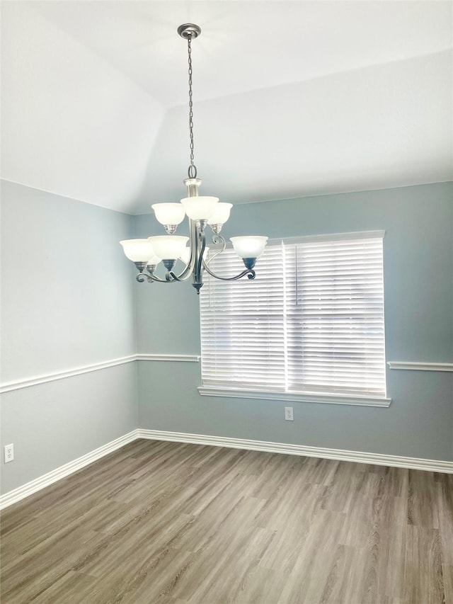 2632 Lake Ridge Dr, Little Elm, TX 75068 - unfurnished dining area featuring wood finished floors, a chandelier, baseboards, and vaulted ceiling