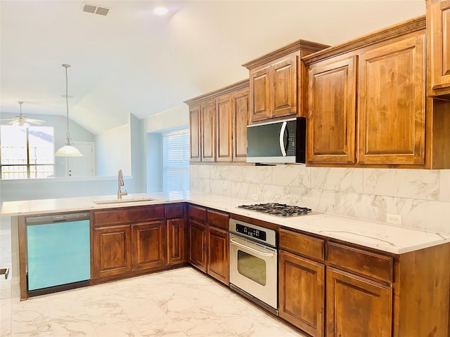 2632 Lake Ridge Dr, Little Elm, TX 75068 - kitchen with stainless steel appliances, a sink, light marble finish flooring, a peninsula, and a ceiling fan