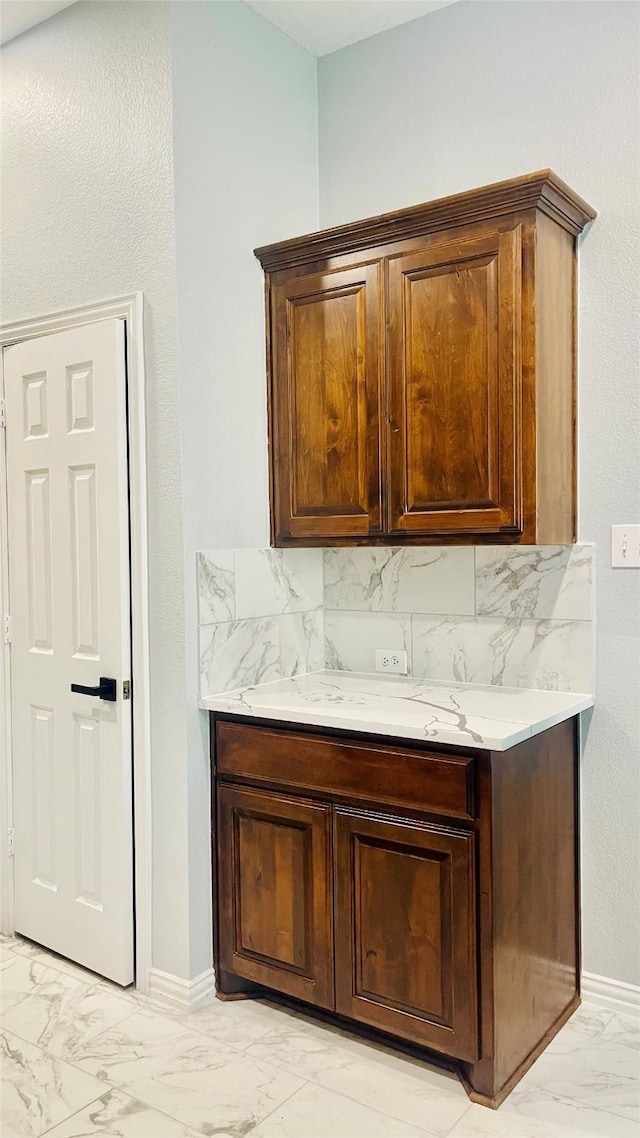 2632 Lake Ridge Dr, Little Elm, TX 75068 - bar area featuring light marble finish floors, baseboards, and tasteful backsplash