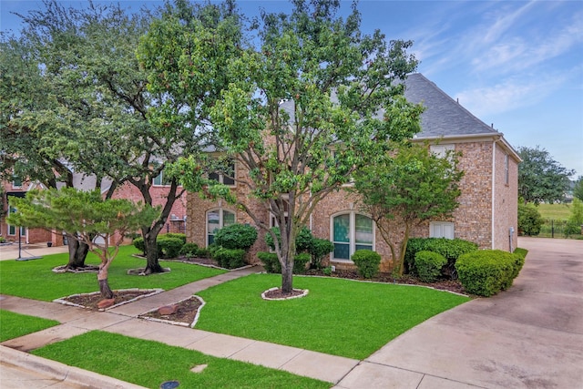 view of front of property with brick siding and a front yard