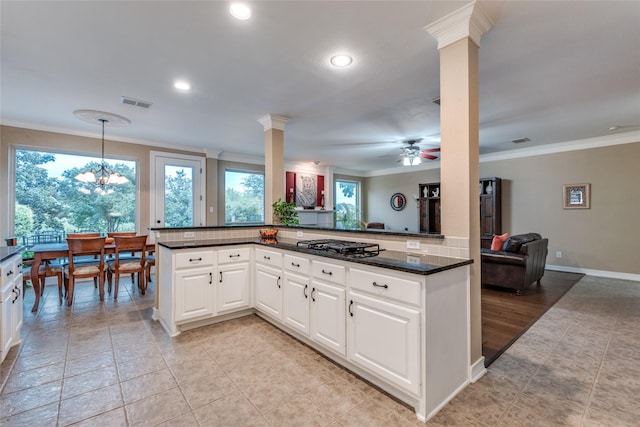 kitchen featuring crown molding, open floor plan, ornate columns, a ceiling fan, and light tile patterned flooring