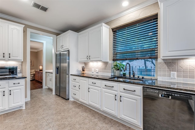 kitchen with appliances with stainless steel finishes, a sink, ornamental molding, backsplash, and white cabinetry