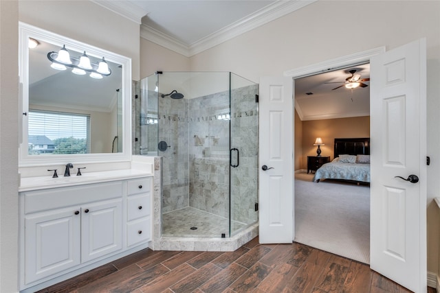 bathroom with crown molding, ensuite bathroom, a stall shower, ceiling fan, and wood finished floors