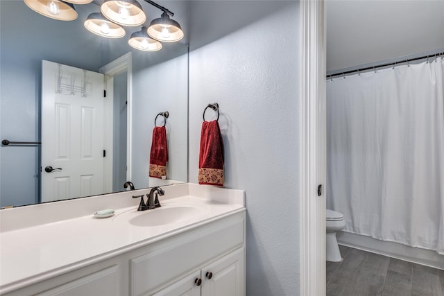 full bath with vanity, toilet, wood finished floors, and shower / bathtub combination with curtain