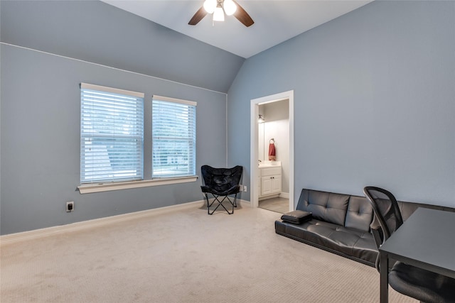 sitting room with a ceiling fan, carpet flooring, lofted ceiling, baseboards, and a desk