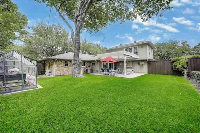 4020 Kerr Ct, Farmers Branch, TX 75244 - rear view of property with a greenhouse, a patio area, and an outbuilding