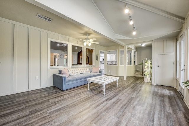 4020 Kerr Ct, Farmers Branch, TX 75244 - living room with a decorative wall, wood finished floors, ceiling fan, rail lighting, and vaulted ceiling