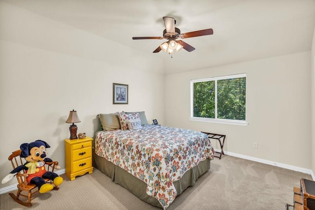 bedroom with light colored carpet, baseboards, and a ceiling fan