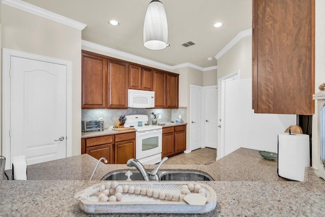 kitchen featuring white appliances, a sink, ornamental molding, tasteful backsplash, and brown cabinetry