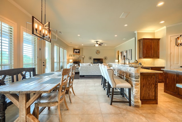 103 Fireside Ct, Mclendon Chisholm, TX 75032 - dining room with recessed lighting, light tile patterned flooring, a chandelier, crown molding, and a ceiling fan