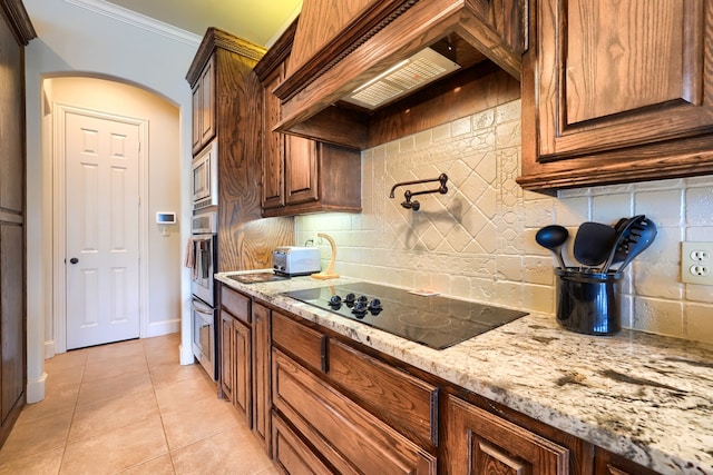 103 Fireside Ct, Mclendon Chisholm, TX 75032 - kitchen featuring black electric stovetop, premium range hood, light stone counters, decorative backsplash, and crown molding