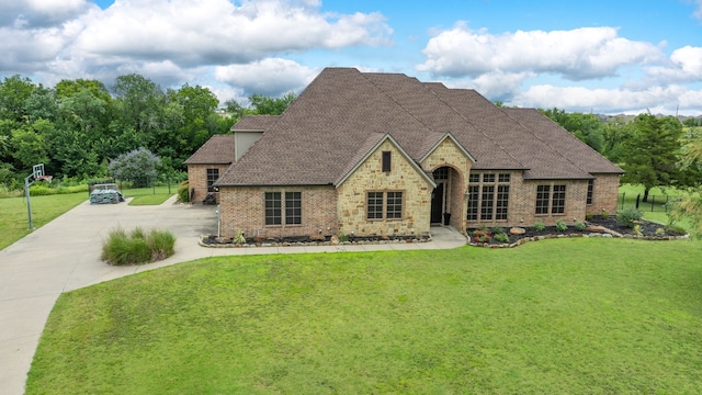 103 Fireside Ct, Mclendon Chisholm, TX 75032 - french country style house with brick siding, a shingled roof, a front lawn, driveway, and stone siding