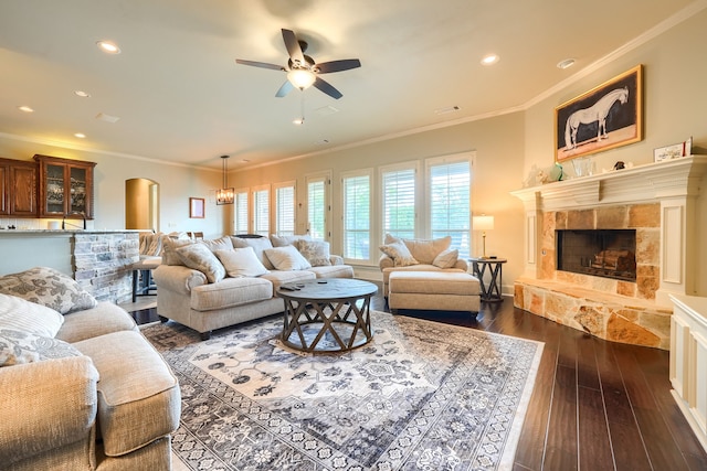 103 Fireside Ct, Mclendon Chisholm, TX 75032 - living area with a ceiling fan, a tiled fireplace, dark wood-style flooring, crown molding, and recessed lighting