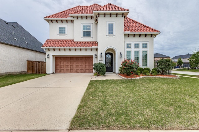 mediterranean / spanish house with stucco siding, an attached garage, concrete driveway, and a tiled roof