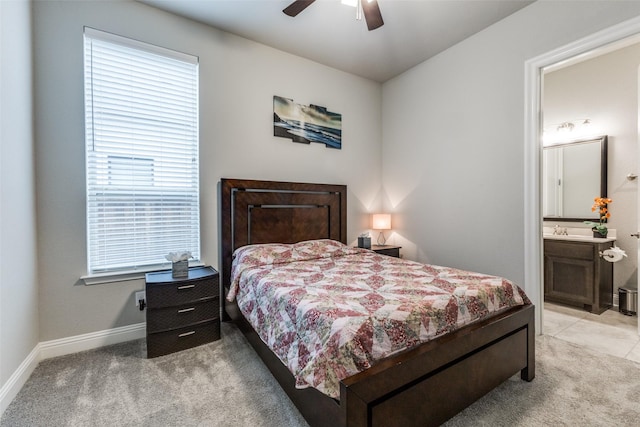 bedroom with light carpet, multiple windows, baseboards, and a ceiling fan