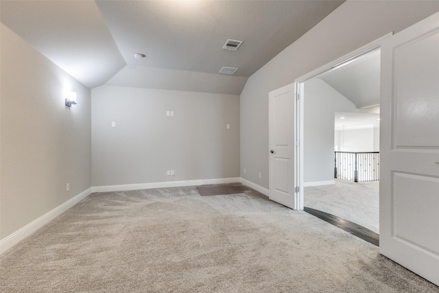 bonus room featuring light carpet, lofted ceiling, and baseboards
