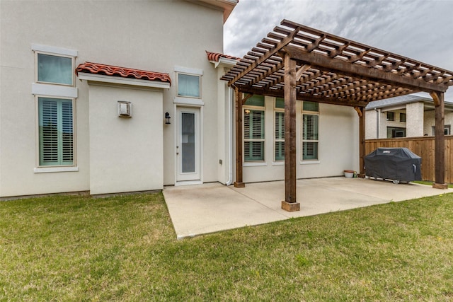 rear view of property featuring a pergola, a tiled roof, a patio area, and stucco siding